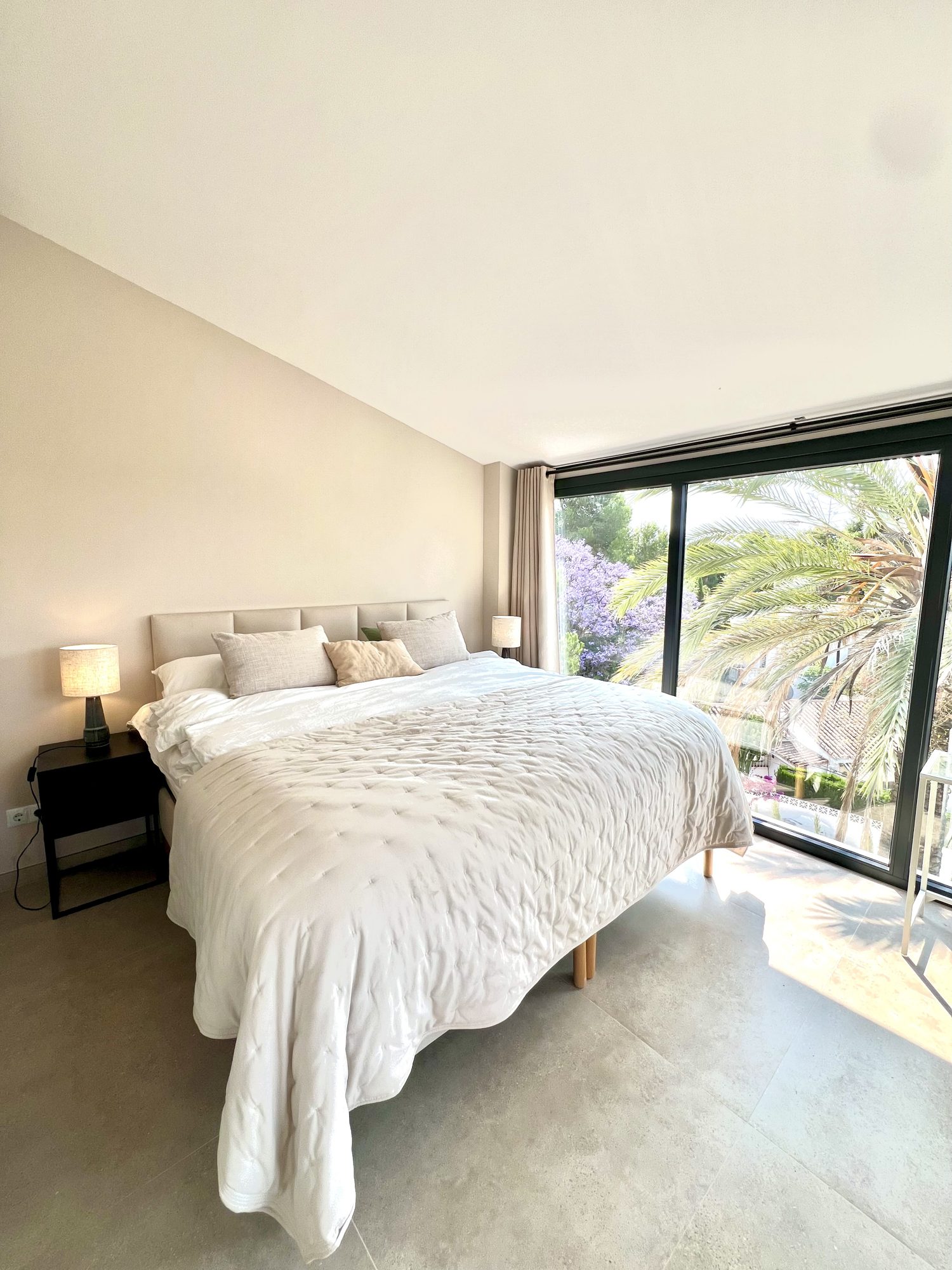 Ricmar — Master bedroom — soft plaster, layered linen, nothing loud.