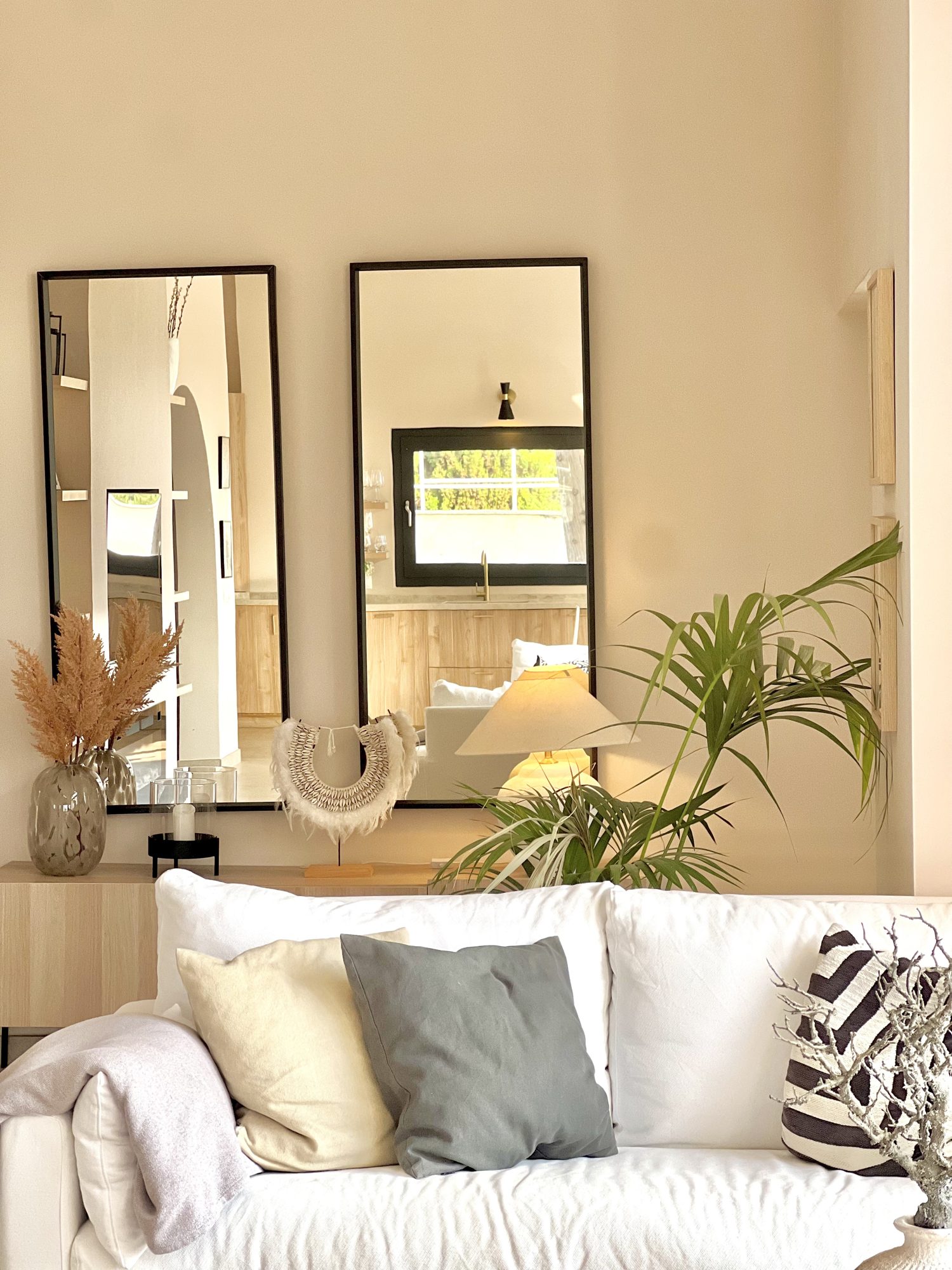 Ricmar — Paired full-height mirrors bounce the afternoon light back across the room.