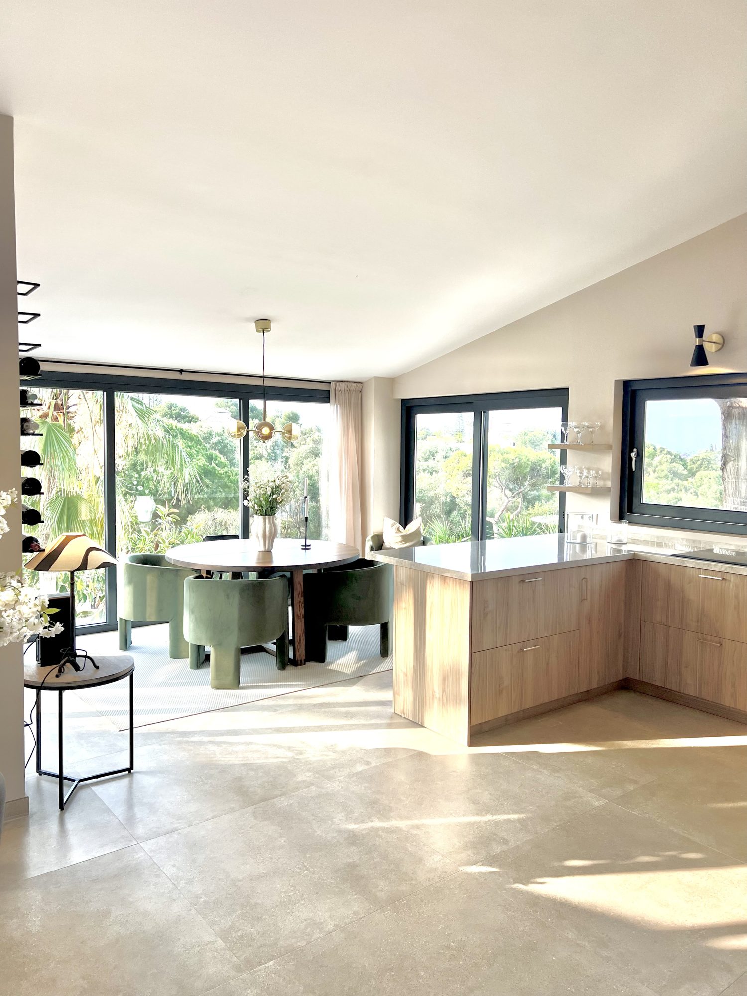 Ricmar — Sculptural lighting kept low over the table.