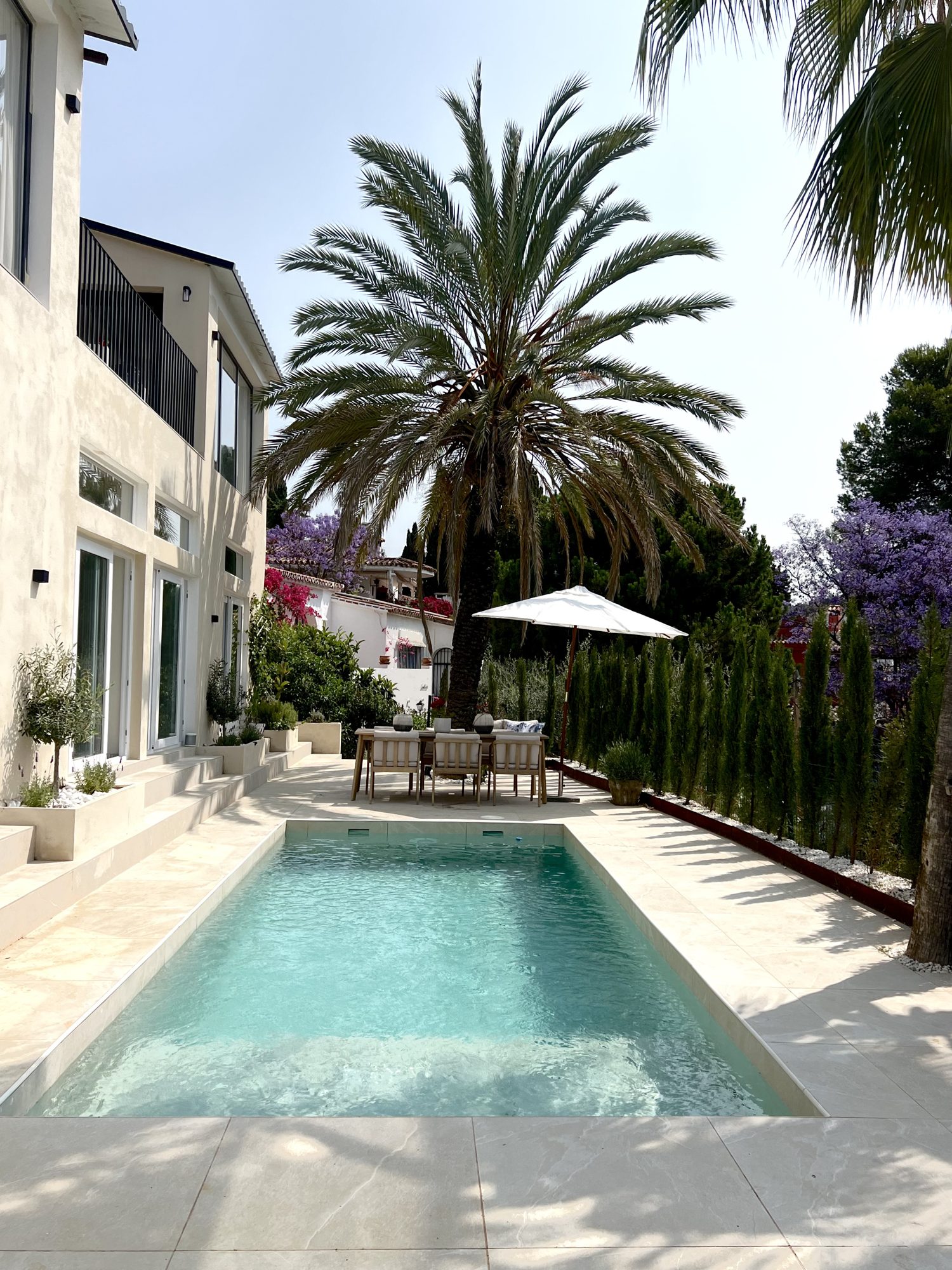 Ricmar — The pool terrace, cut into the slope.